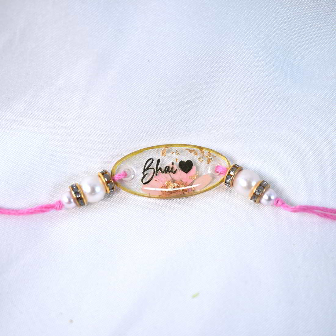 Beautiful Transparent With Original Pink Flower With Golden Text Bhai With Beautiful Heart Rakhi  